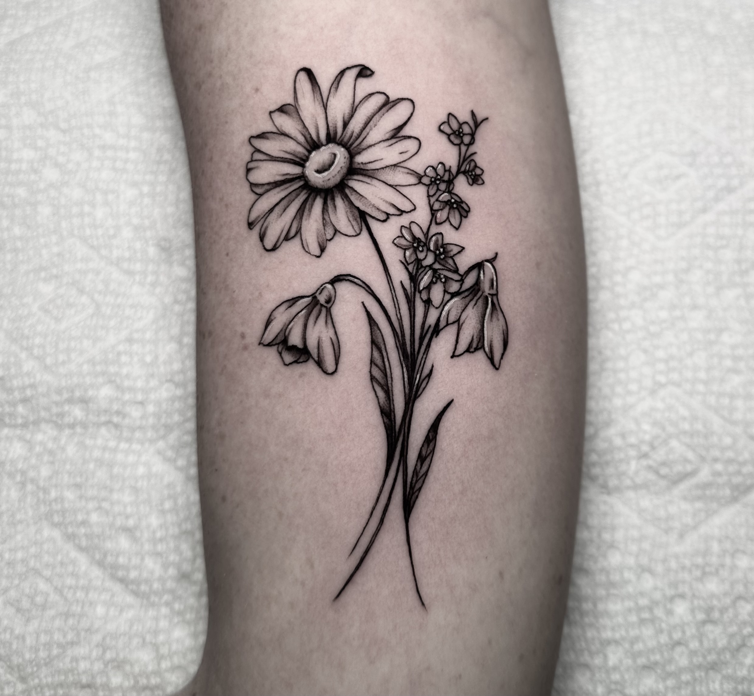 Fine-line floral tattoo