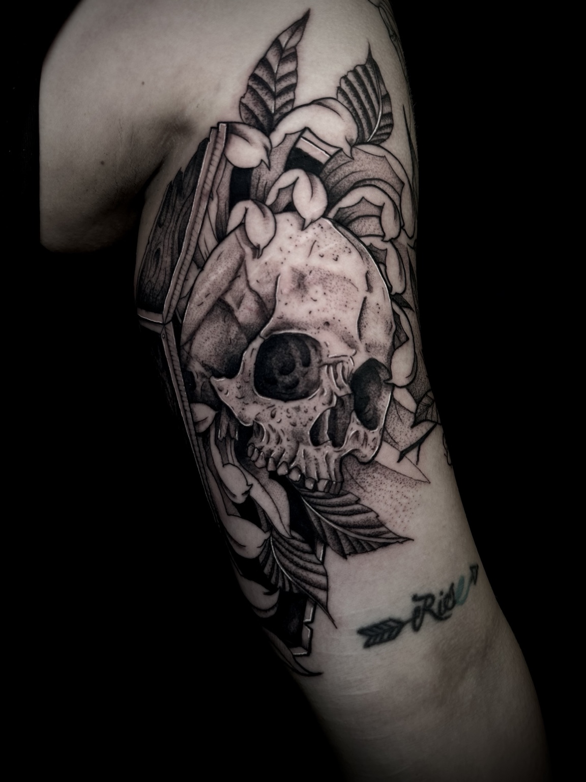 Skull and floral blackwork tattoo